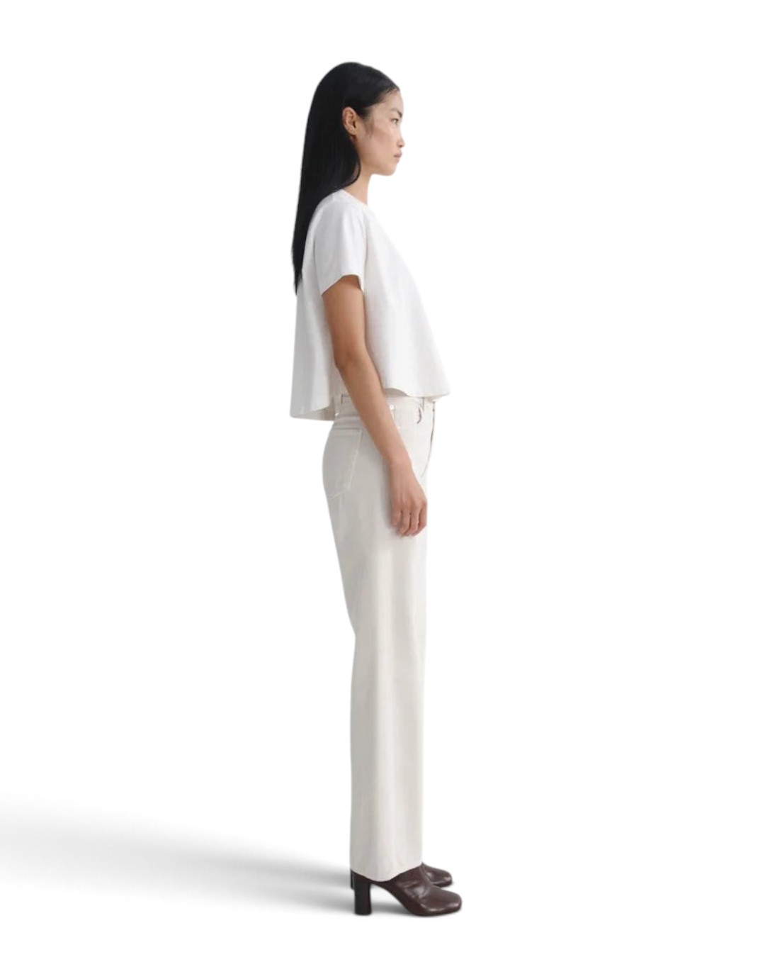 Jack Jerome model wearing AGOLDE Ren high-rise wide-leg bone corduroy jeans and a white top, side profile view
