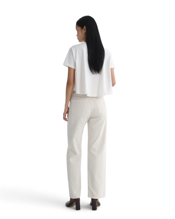 Jack Jerome AGOLDE Ren wide-leg corduroy jeans in bone, back view on a model wearing a white top and dark heels.